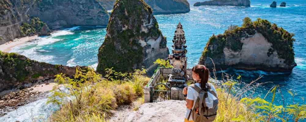 Woman looking out at ocean from up high